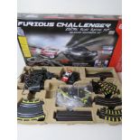 A Furious Challenger electric road racing set inc two cars, controllers and various track,