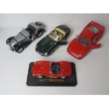 Four scale model vehicles being a BMW 328,