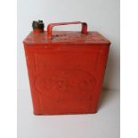 A red painted vintage Esso can with brass Esso cap, measuring approx 25cm wide.