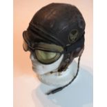 A WWII US Air Force type B-6 helmet with WWII goggles made by Fisher Spring Co and Radio headset