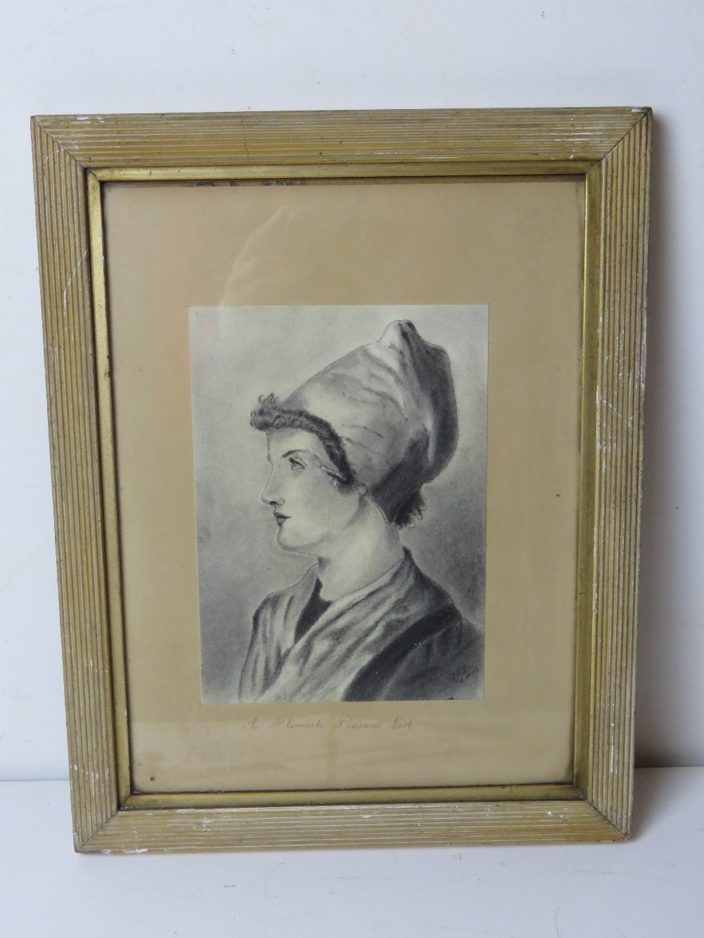 A portrait print titled 'A Flemish Peasant Girl', framed and glazed.