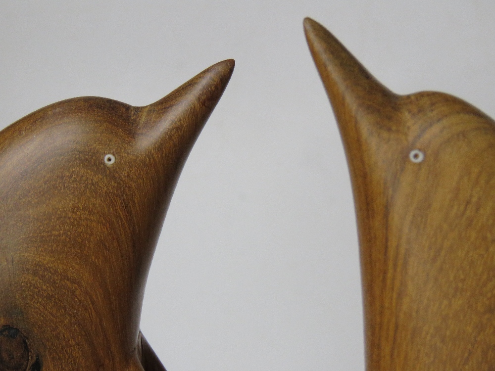 A pair of carved wooden dolphin figurines, one having repair to dorsal fin, each standing 37cm high. - Image 3 of 5