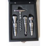 A set of three wine stoppers with corkscrew in presentation box.