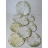 A cake plate with eight matching side plates marked England to base in cream and green floral
