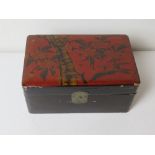 An Oriental style black and red lacquered box.