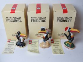 Guinness; a set of three Royal Doulton limited edition figurines being Christmas Toucan,