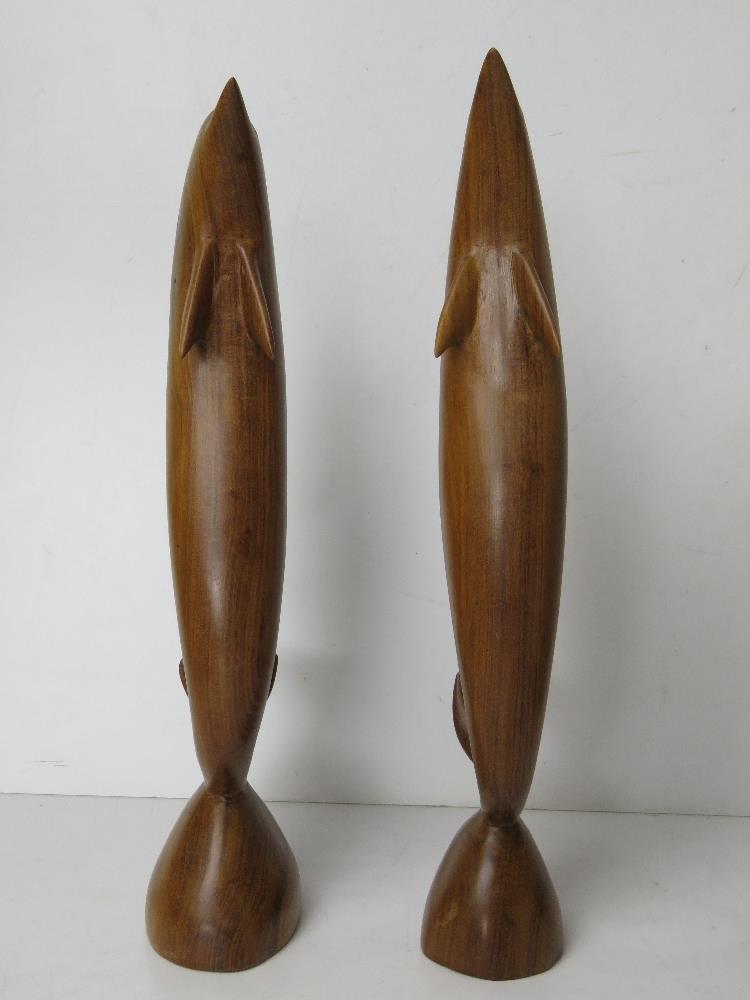 A pair of carved wooden dolphin figurines, one having repair to dorsal fin, each standing 37cm high. - Image 2 of 5