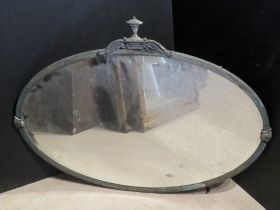 A large oval mirror having Regency style metal frame.