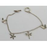 A silver charm bracelet having flower, dragonfly, bee and butterfly charms upon, stamped 925.