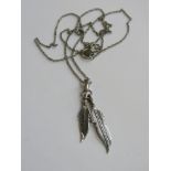 A Native American style two feather pendant in 925 silver on a 925 silver chain.