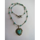 A Native American Navajo style sterling silver and turquoise necklace with heart shaped pendant on