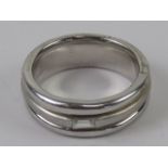 A hallmarked silver ring having baguette cut cz to central brushed finish band having polished
