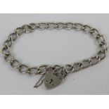 A HM silver curb link chain charm bracelet having heart padlock clasp,