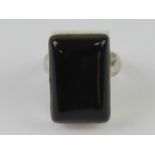 An onyx ring, the rectangular cabachon set in white metal stamped 925, size L-M.
