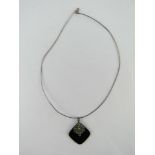 An Art Deco style silver and marcasite pendant measuring 4cm in length, stamped 925,