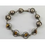 A silver geometric design tiger's eye cabachon bracelet stamped 925 and measuring 21,5cm in length.