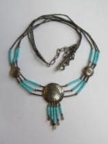 A Native American Navajo style sterling silver and turquoise necklace having central roundel