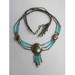 A Native American Navajo style sterling silver and turquoise necklace having central roundel