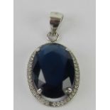 A blue stone pendant stamped 925, 2.8cm in length.