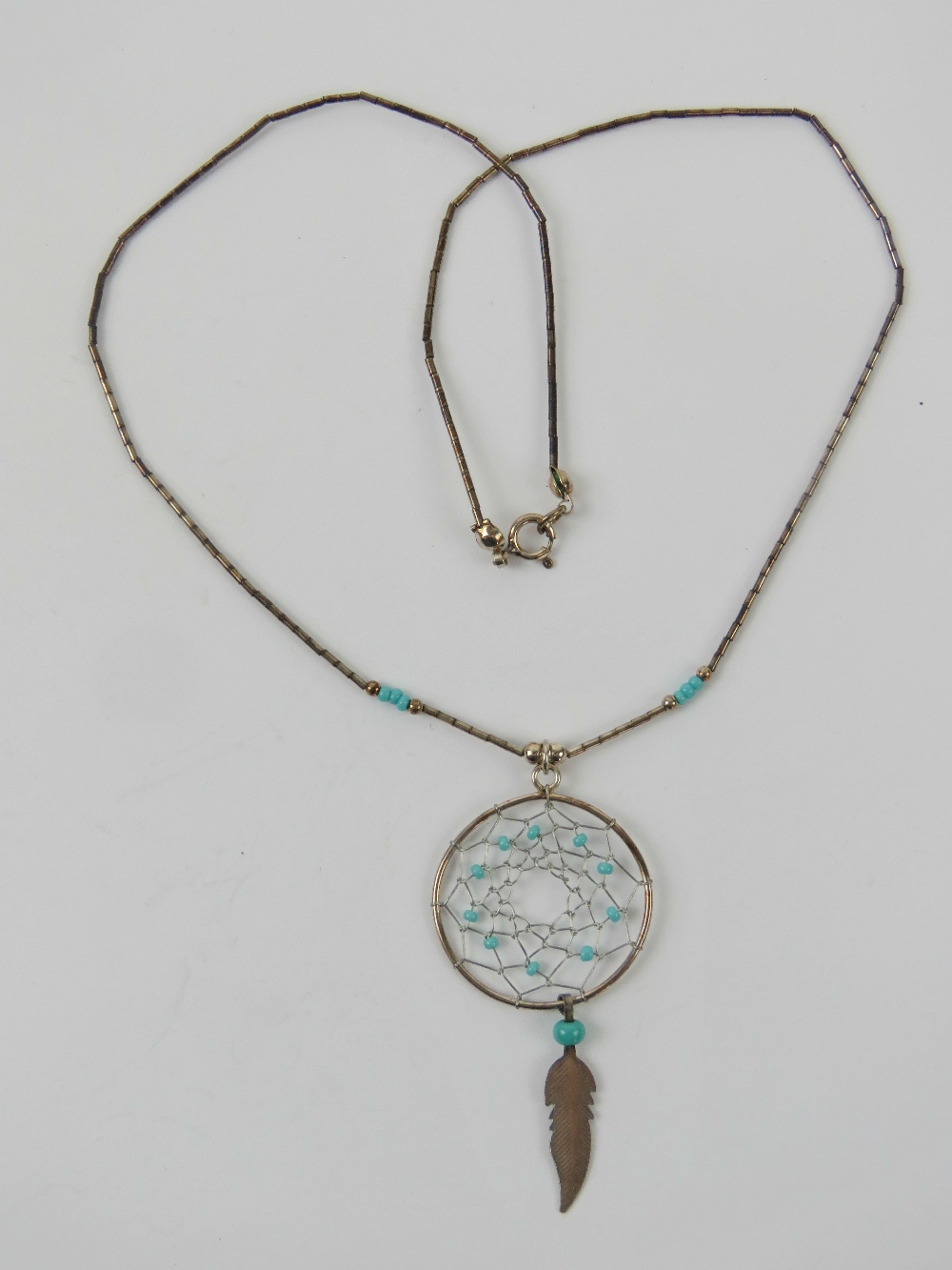 A Native American dream catcher necklace, Navajo style, stamped 925 to the clasp.