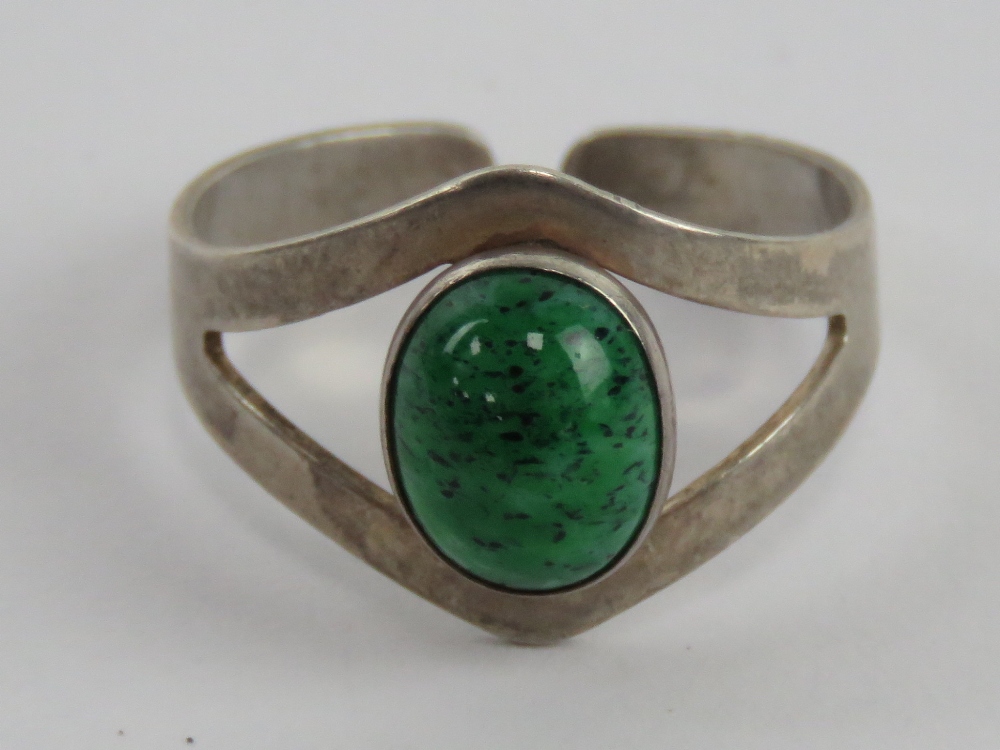 A sterling silver and green hardstone ring of geometric design, slightly adjustable size S-T.