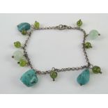 A 925 silver bracelet set with turquoise agate and glass beads.