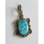 A Native American style white metal and turquoise pendant, no apparent hallmarks, 2.5cm inc bale.