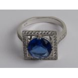 A silver and blue stone ring, size R, stamped 925.