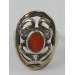 A silver and carnelian ring having pierced pattern in oval frame, stamped 925, size M-N.