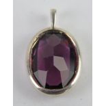 A faceted purple stone pendant, no apparent hallmarks, 2.3cm in length.