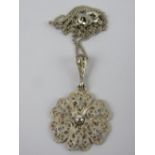 A continental silver floral filigree pendant, stamped 935 and measuring 2.