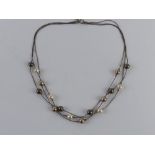 A silver and faux pearl necklace by Magnolia, stamped 925 with designer's label upon,