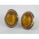 A pair of Baltic amber stud earrings each approx 18 x 14mm overall.