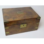 An antique writing slope having brass corner bracing, escutcheon and plate to lid,