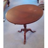 A late 19thC mahogany circular occasional table raised over short gun barrel stem terminating in