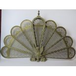 A 'peacock' fantail brass decorative fire-spit guard having nine panels, 96cm wide, 63cm high.