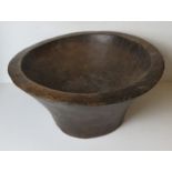 A large hand carved wooden Indo-Asian baking bowl approx 55cm dia.