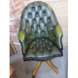 A green leatherette Chesterfield style office chair having high back and pine base,