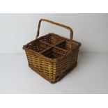 A wicker basket to hold four bottles, having swing handle over, approx 24cm wide.