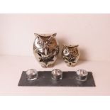 A pair of graduated silver painted owl tealight holders together with a trio of glass tealights on