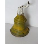 An antique cast metal doorstop in the form of a bell, top a/f, over-painted,