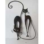 A pair black painted metal cat themed wall decorations.