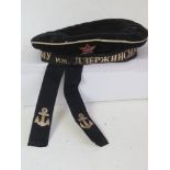 A Soviet Navy hat having ships ribbon, l