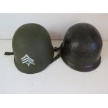 A US M1 helmet with liner, chin strap an