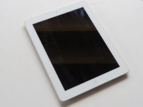 An Apple iPad A1458 white, 9.7" screen.