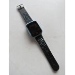 An unknown brand smart watch on blue and