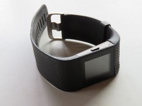 A FitBit on black rubberised strap.