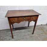 A low boy style occasional table having central drawer flanked by twin box drawers with brass drop