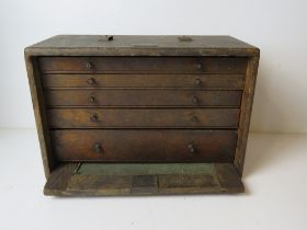 A vintage toolbox having drop in front with brass lock,