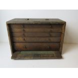 A vintage toolbox having drop in front with brass lock,